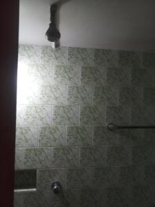 a shower with a stone wall in a bathroom at Shanti Home Stay in Jāmul