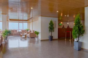 a lobby with chairs and potted plants in a building at Treenz Hotel in Gangtok +42 photos