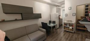 a small living room with a couch and a table at Casa Fiocchi b&b in Lacchiarella