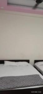 a close up of a bed in a bedroom at Gajlaxmi HOTEL UJJAIN in Ujjain