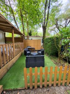 a backyard with a wooden fence and green grass at L évasion in Saint-Thomas-en-Royans +6 photos
