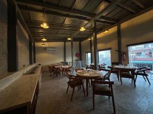 a restaurant with tables and chairs in a room at Click Inn Express in Dehradun