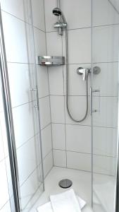 a bathroom with a shower with a glass door at Wohnung-Moewe-2 in Westerland (Sylt)
