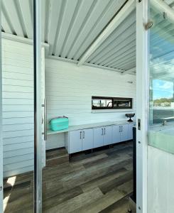 a bathroom with white cabinets and a bath tub at Dior Maison de Reve- Private Penthouse in Stellenbosch