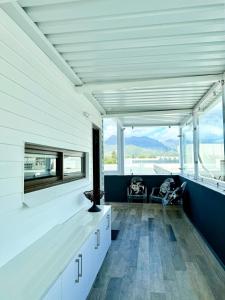 a room with white cabinets and large windows at Dior Maison de Reve- Private Penthouse in Stellenbosch +32 photos