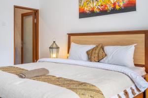 a bedroom with two beds with white pillows at Omm - Luxury Awaits - Brand New 3-Bedroom Villa with Huge Pool in a Perfect Spot in Canggu +5 photos