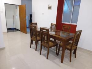 a dining room with a wooden table and chairs at Dil Apartments 2 in Mount Lavinia +10 photos