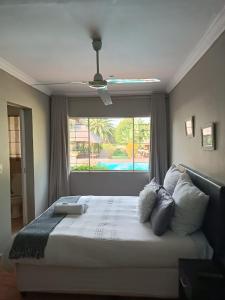 a bedroom with a large bed with a window at Glen Rest Country Lodge in Midrand