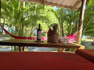 a table with two bottles of wine and a basket at Paradise Villas Koh Rong Sanloem in Koh Rong Sanloem +17 photos