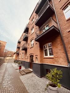 a brick building with balconies on the side of it at KOBIELA Luxury LOFT City Center in Katowice