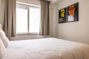 a bedroom with two posters on the wall and a bed at House 22 longstay in Kortrijk