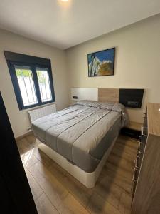 a bedroom with a bed and a flat screen tv at Chalet independiente en zona residencial rural con piscina privada in Jaén +41 photos