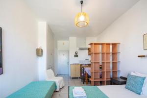 a living room with two beds and a kitchen at Old town studio with balcony, Marylee's studios #3 in Rethymno