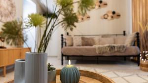 a living room with a couch and a table with a candle at The Greens premium house - Luxury Apartment in the Heart of the City by Villa Mana Gers in Zakynthos Town +37 photos