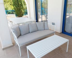 a couch and a table on a patio at Azzurro Holiday Villas in Peyia