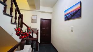 a hallway with a staircase with a painting on the wall at 金門58旅宿 可包棟 好停車 近市區 近金門大橋 in Hsia-pu-hsia