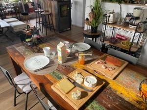 a wooden table with plates and food on it at Liberté Room 2 Chambre privée en colocation conviviale ! in Nanterre