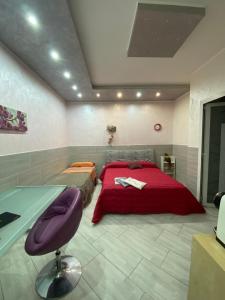 a bedroom with a bed and a desk in it at Luxury Rosaverde in Frattamaggiore