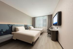 Voodi või voodid majutusasutuse Atour Hotel Wuhan Hubei University Xudong toas