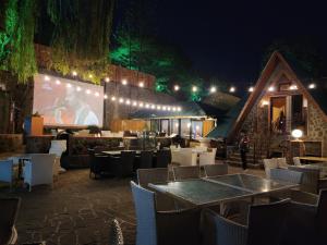 a restaurant with tables and chairs at night at Maisonette Firhill Hotel & Resort in Murree +156 photos