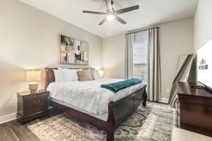 a bedroom with a bed and a ceiling fan at Contractor Friendly 3 Kings Pet Welcome in Lake Charles
