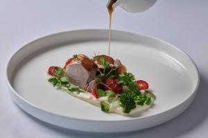 a white plate with a piece of food on it at TUI Magic Life Candia Maris - Adults Only in Amoudara Herakliou