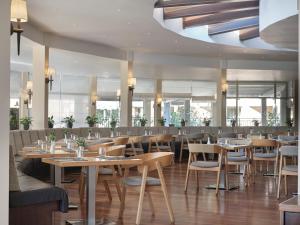 a restaurant with tables and chairs and a ceiling at TUI Magic Life Candia Maris - Adults Only in Amoudara Herakliou