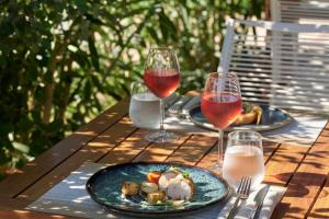a table with two plates of food and two glasses of wine at TUI Magic Life Candia Maris - Adults Only in Amoudara Herakliou