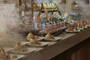 a buffet line with plates of food on display at TUI Magic Life Candia Maris - Adults Only in Amoudara Herakliou