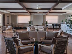 a large room with chairs and tables and a piano at TUI Magic Life Candia Maris - Adults Only in Amoudara Herakliou