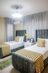 Postel nebo postele na pokoji v ubytování Residencial Nany