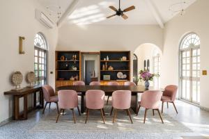 a dining room with a table and chairs at LohonoStays Regato Villa E in Siolim
