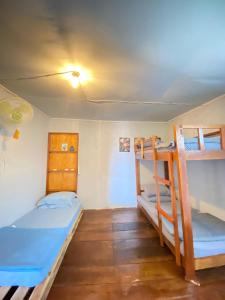 a room with two bunk beds and a ceiling at Evergreen Lodge in Padang