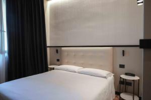 Posteľ alebo postele v izbe v ubytovaní Hotel Universo