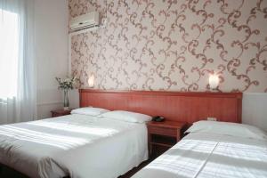 Posteľ alebo postele v izbe v ubytovaní Hotel Universo