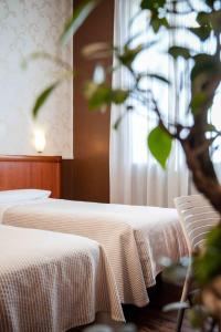 Posteľ alebo postele v izbe v ubytovaní Hotel Universo