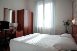 Posteľ alebo postele v izbe v ubytovaní Hotel Universo