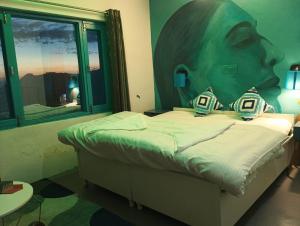 a bedroom with a bed with a large head on the wall at Dhauladhar Eternals in Dharamshala