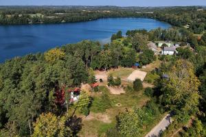 an aerial view of a house on the shore of a lake at Instytut Wypoczynku in Sulęczyno