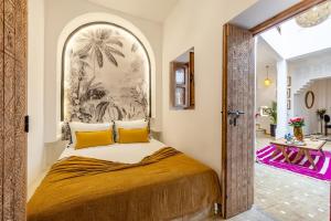 a bedroom with a large bed with yellow pillows at Riad Dar Catalia-Exclusive&HeatedPool-FreeBreakfas in Marrakech +74 photos