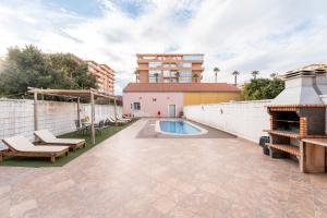 a patio with a swimming pool and a building at Unique Patacona in Valencia