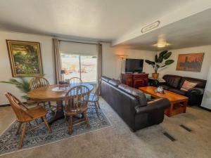 a living room with a couch and a table at Angostura Oasis in Hot Springs +59 photos