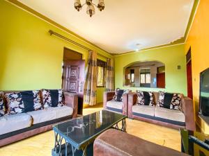a living room with couches and a coffee table at KAZ Appartment in Kampala