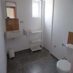 a bathroom with a toilet and a sink at Villa Vallon Pont d'Arc in Vallon-Pont-dʼArc