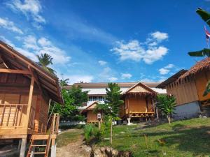 a group of houses with a blue sky in the background at The Sunset View Lanta in Phra Ae beach