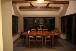 a dining room with a wooden table and chairs at Ballydonnellan in Westport