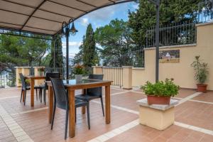 a patio with a table and chairs on a patio at Hotel Bia Maore in Baunei