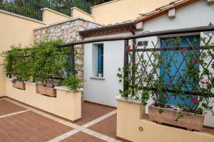 a house with plants on the side of it at Hotel Bia Maore in Baunei