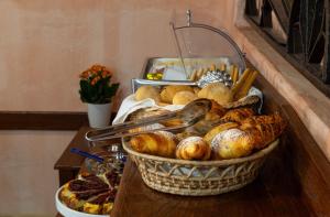a basket of bread and pastries on a table at Hotel Bia Maore in Baunei