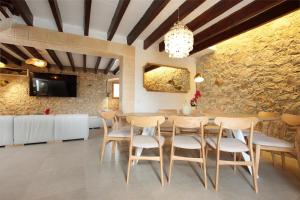 a dining room with a table and chairs at Villa Alordes in Pollença